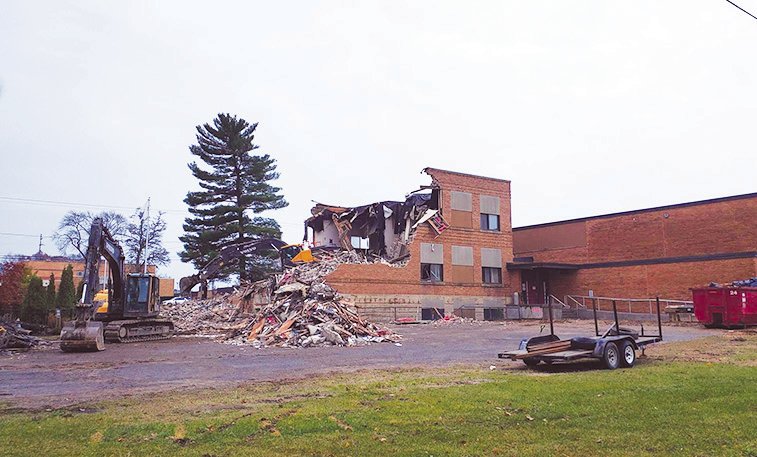 The “twin pines” are now a single pine after one was taken down during the recent demolition of the Harrison school building.